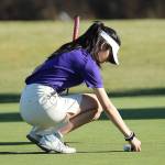 Jessica Aguilar prepares to putt for Oak Harbor. (Photo by John Fisken)