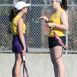 Caitlin Dennen, left, and doubles partner Erika Polack discuss their play.(Photo by John Fisken)