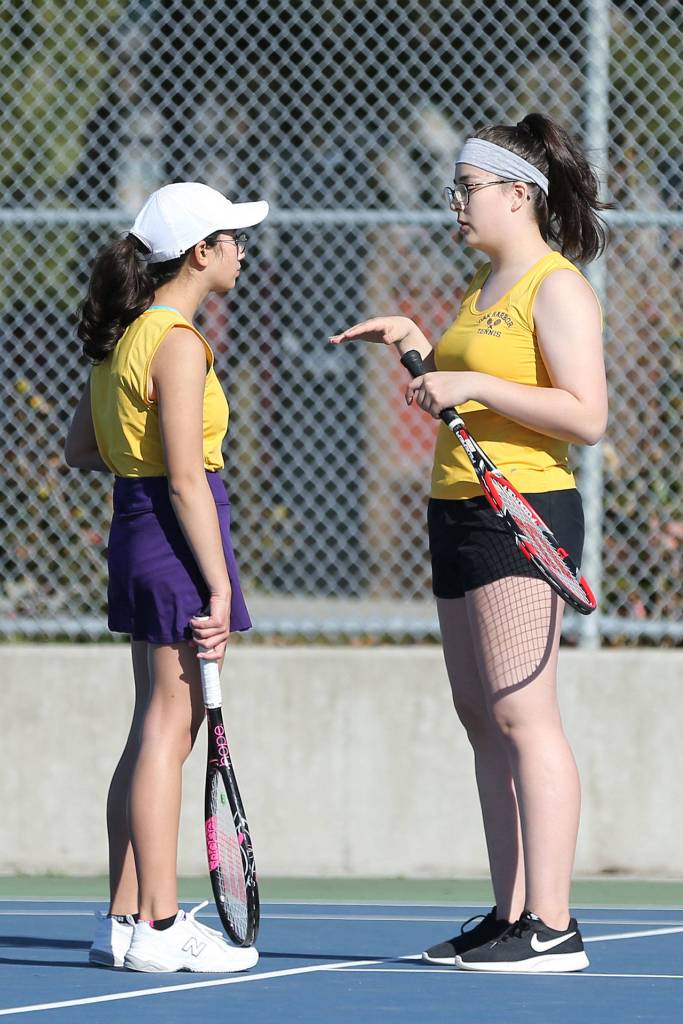 Caitlin Dennen, left, and doubles partner Erika Polack discuss their play.(Photo by John Fisken)