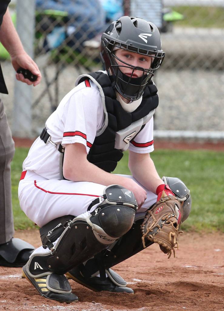 Coupeville catcher Mason Grove looks to the bench for the pitch call. (Photo by John Fisken)