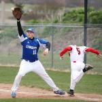 Matt Hilborn beats out an infield hit as Chimacum first baseman Cody Clark makes the catch.(Photo by John Fisken)