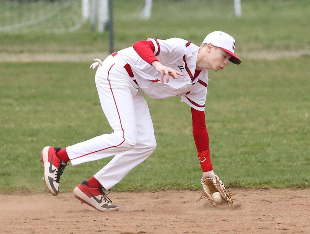 Coupeville second baseman Daniel Olson scoops up a grounder.(Photo by John Fisken)