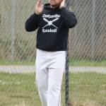 Coach Chris Smith relays signals to a Coupeville batter.(Photo by John Fisken)
