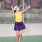 Oak Harbors Caitlin Dennen serves in her third doubles match. (Photo by John Fisken)