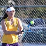 MJ Timm volleys in her first singles match.(Photo by John Fisken)