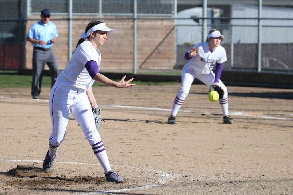 Cierra LeGendre, left, throws a pitch while Oak Harbor first baseman Kait Scheer prepares to play defense.(Photo by John Fisken)
