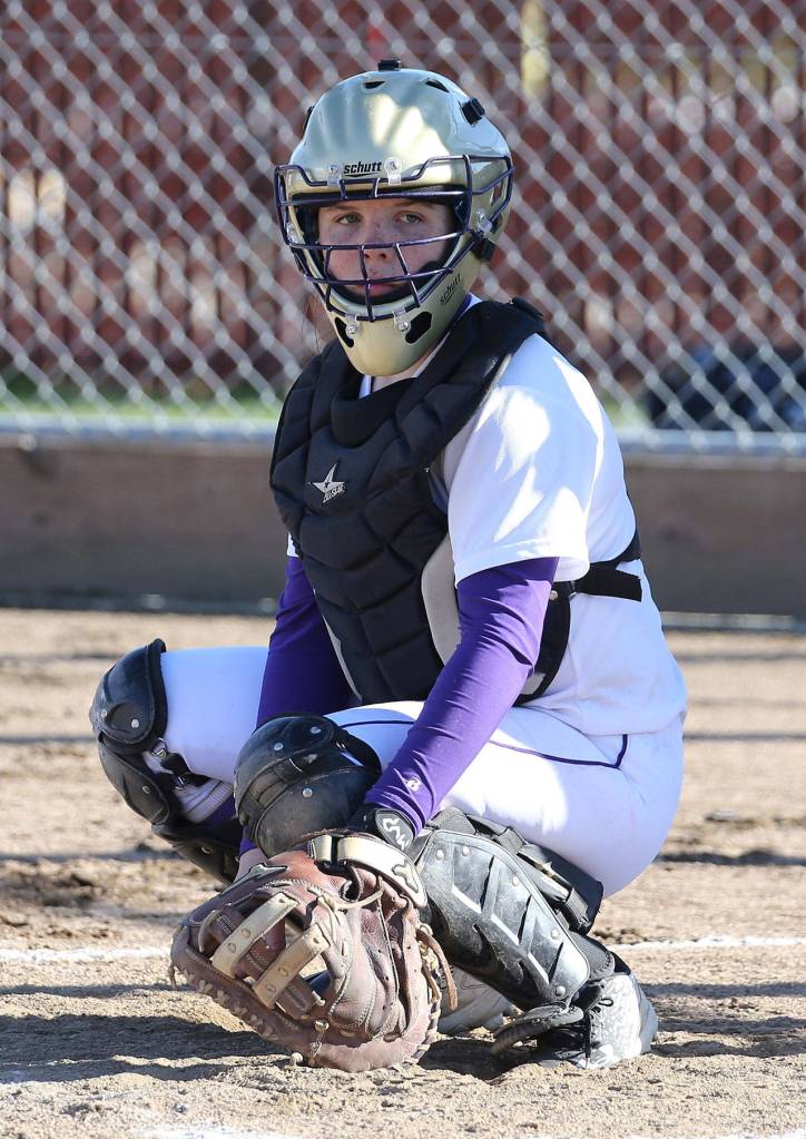 Oak Harbor catcher Sam Scott looks to the bench for the pitch selection.(Photo by John Fisken)