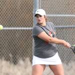Genna Wright delivers a backhand in first singles.(Photo by John Fisken)