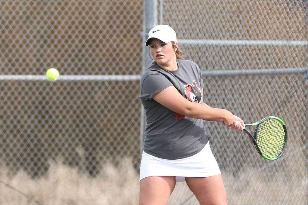 Genna Wright delivers a backhand in first singles.(Photo by John Fisken)