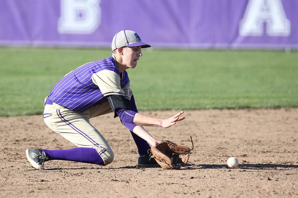 Shortstop Joe Dixon scoops up a ground ball.(Photo by John Fisken)