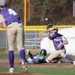 Oak Harbor pitcher Jacksyn Pawlowics (4) throws to first baseman Andrew Dixon in an attempt to pick off Marysville Getchells Trevor Loucks.(Photo by John Fisken)