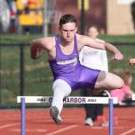 Gabriel Daggett flies to third place in the 300 hurdles.(Photo by John Fisken)