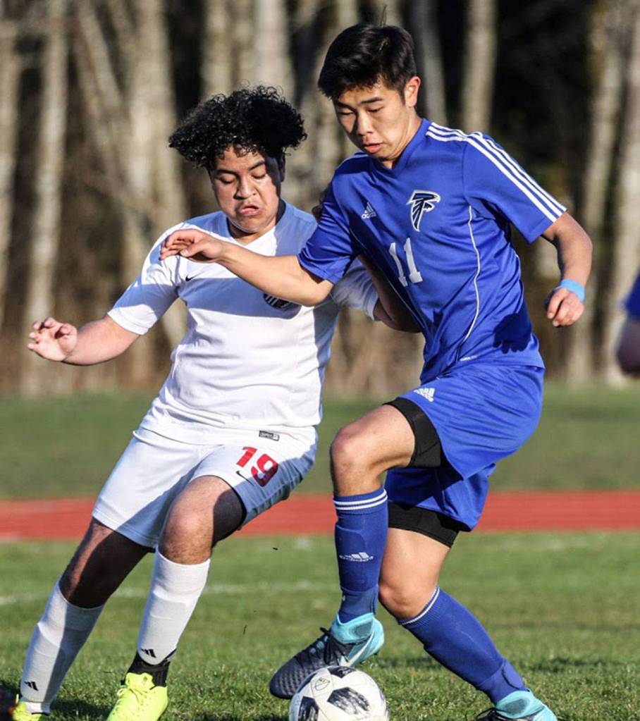 Coupevilles Alex Jimenez, left, tangles with Falcon Graham Colar for possession.(Photo by Matt Simms)
