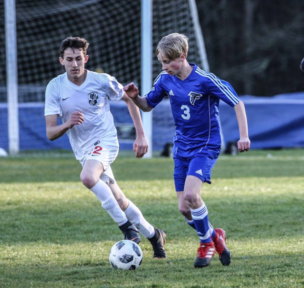 Xavier Murdy, left, chases South Whidbeys Thomas Simms.(Photo by Matt Simms)