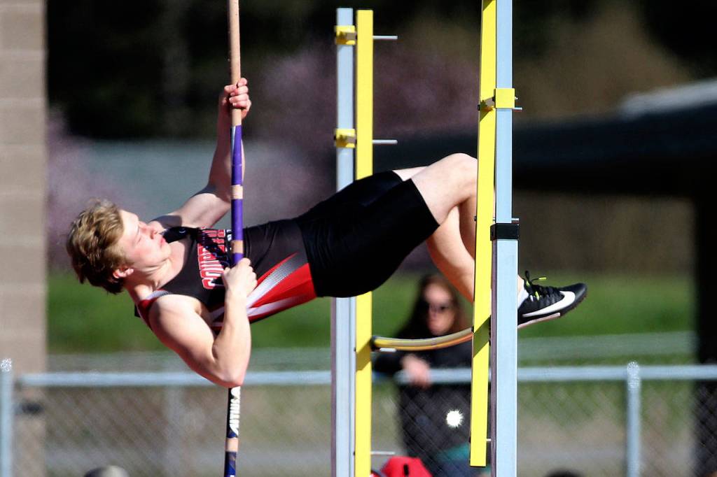 Kyle Burnett soars in the pole vault.(Photo by John Fisken)