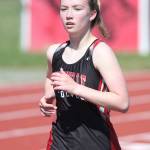 Lucy Sandahl runs to first place in the 1,600 meters.(Photo by John Fisken)