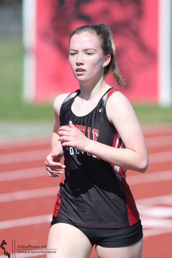Lucy Sandahl runs to first place in the 1,600 meters.(Photo by John Fisken)