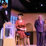 In a perfume store, salesman Steven Kodaly (Douglas Langrock) helps a customer, played by Coqui Melnick. Store owner (Kevin Wm. Meyer) and manager Georg Nowack (Karl Borja) both look on.