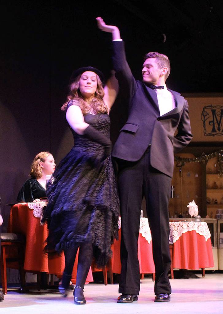 In a scene at the nightclub, Café Imperiale, ensemble members Sabrina Loomis and Colston Polly take a turn on the dance floor.