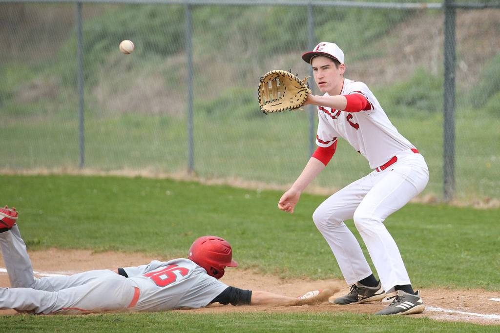 First baseman Ulrik Wells receives a pickoff throw as Kings Ethan Britt dives back to the bag.(Photo by John Fisken)