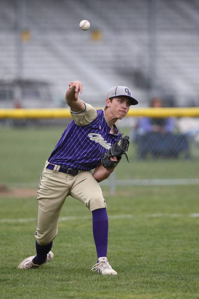 Oak Harbor pitcher Jacksyn Pawlowicz throws to first base Tuesday after fielding a bunt.(Photo by John Fisken)
