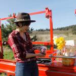 Tonneli Gruetter holds a jar of colorful, edible flowers in shades of pink, purple and white. The farm specializes in providing unique arrangements for bouquets.