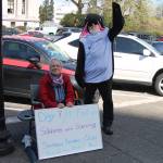 Photo provided. Lanni Johnson sitting in front of the capitol building steps where she has been on a hunger strike for the last 9 days to save the Southern Resident Orcas. Johnson is joined by supporter, Phil Myers, who can be seen in an orca onesie.