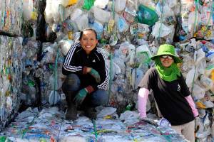 Photos by Patricia Guthrie/Whidbey News Group<em></em>                                <em>Yu Williams, left, and Polly Schweer pose on the mounds of plastic that they bundle to get ready for hauling from Freelands Island Recycling. They are the miracle workers of this place, says owner Jill Campbell. </em>
