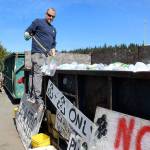 At Freelands Island Recycling, James Bogart pulls out a clam shell plastic container that is no longer accepted as an item that can be recycled. Only bottles and jugs of plastic labeled with No. 1 and No. 2 are taken. Experts urge people to ask at transfer stations if they have questions about what is and isnt recyclable. (Photo by Patricia Guthrie/Whidbey News Group)