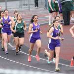 Oak Harbors Evelyn Osburn, second from right, and Stephanie Mayer run with the leaders in the 1,600 Thursday. (Photo by John Fisken)