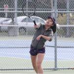 Frances Empinado serves during her second doubles match. (Photo by John Fisken)