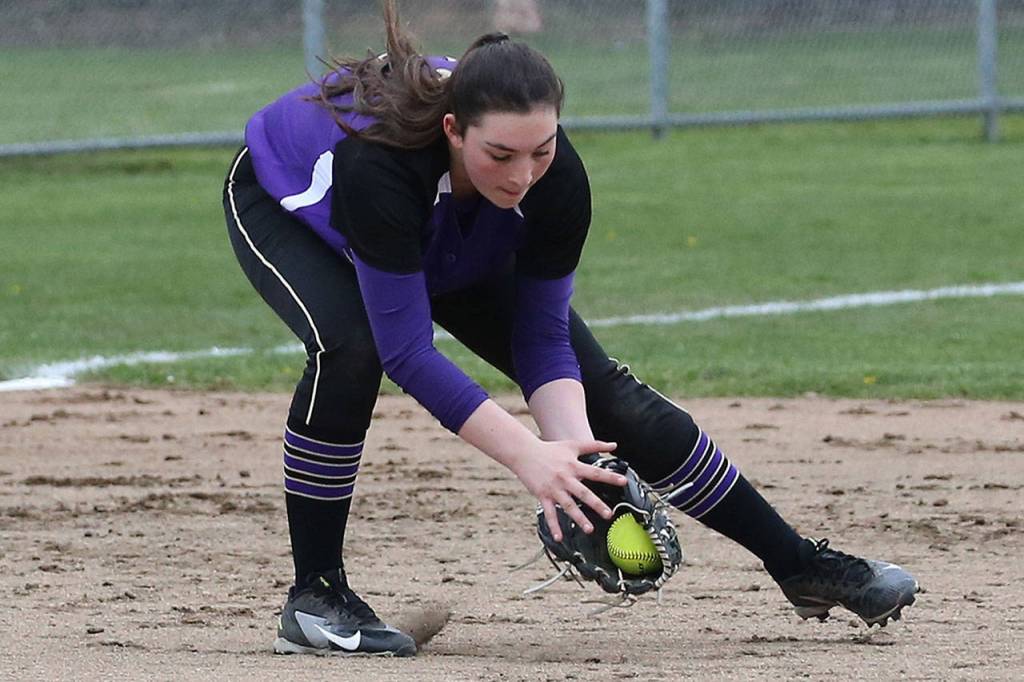 Oak Harbor third baseman Madisyn Erbe snags a ground ball.(Photo by John Fisken)