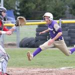Oak Harbors Andrew Dixon races home to score on a sacrifice fly as Stanwoods Braden Joyner awaits the throw.(Photo by John Fisken)