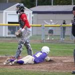 Kyto Morrow slides across home plate for the winning run Tuesday.(Photo by John Fisken)