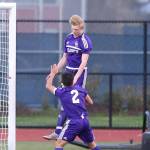 William Dylander heads the ball for the Wildcats as Kanoa King looks on. (Photo by John Fisken)