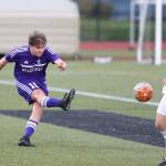 Julian Hinkle blasts a kick by Snohomishs John Flores. (Photo by John Fisken)