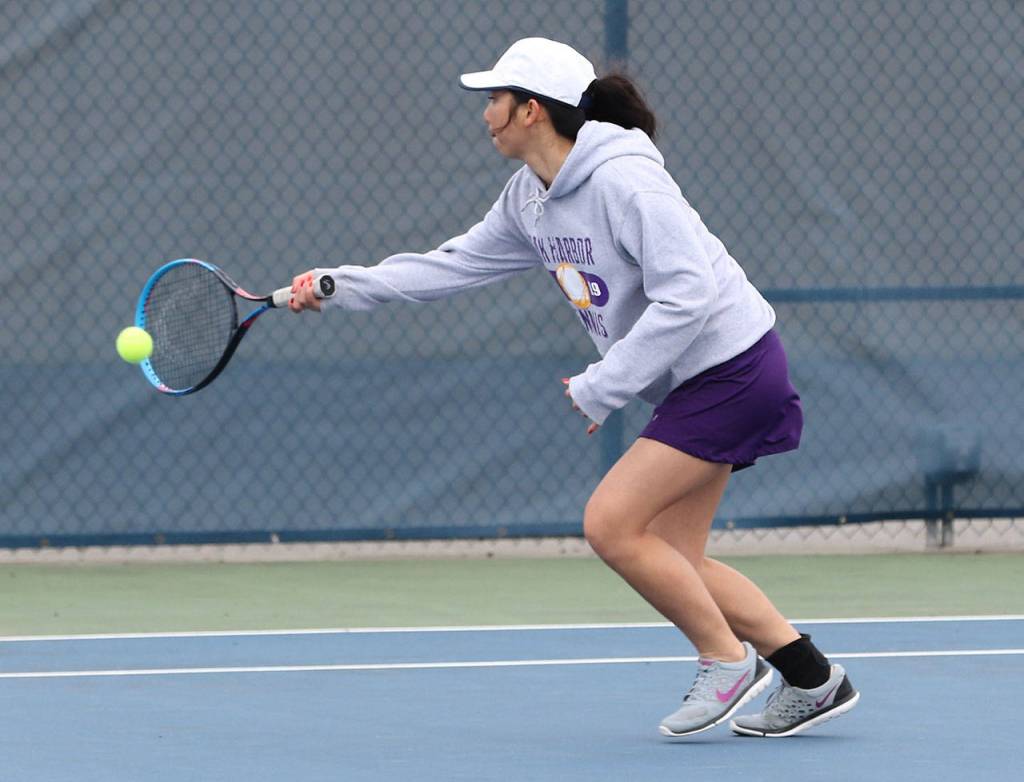 Anne-Jun Lemoine returns a shot in third doubles.(Photo by John Fisken)