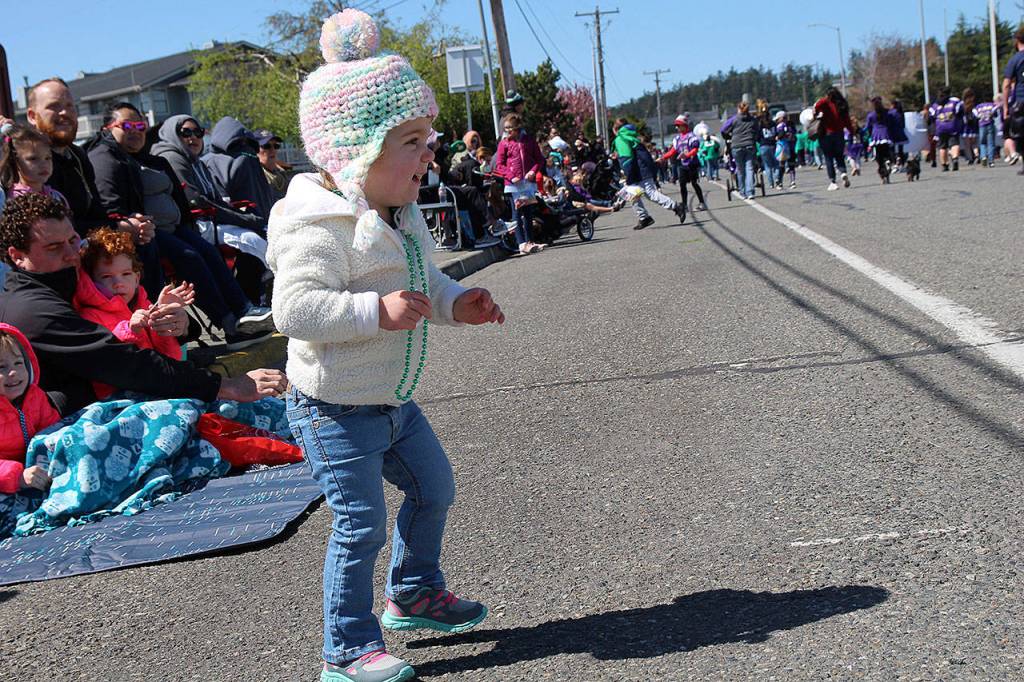 Amelia MacLean, 2, dances with excitement as the Holland Happening parade proceeds.