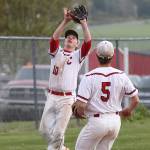 Third baseman Shane Losey settles under a p0p fly while Matt Hilborn looks on.(Photo by John Fisken)