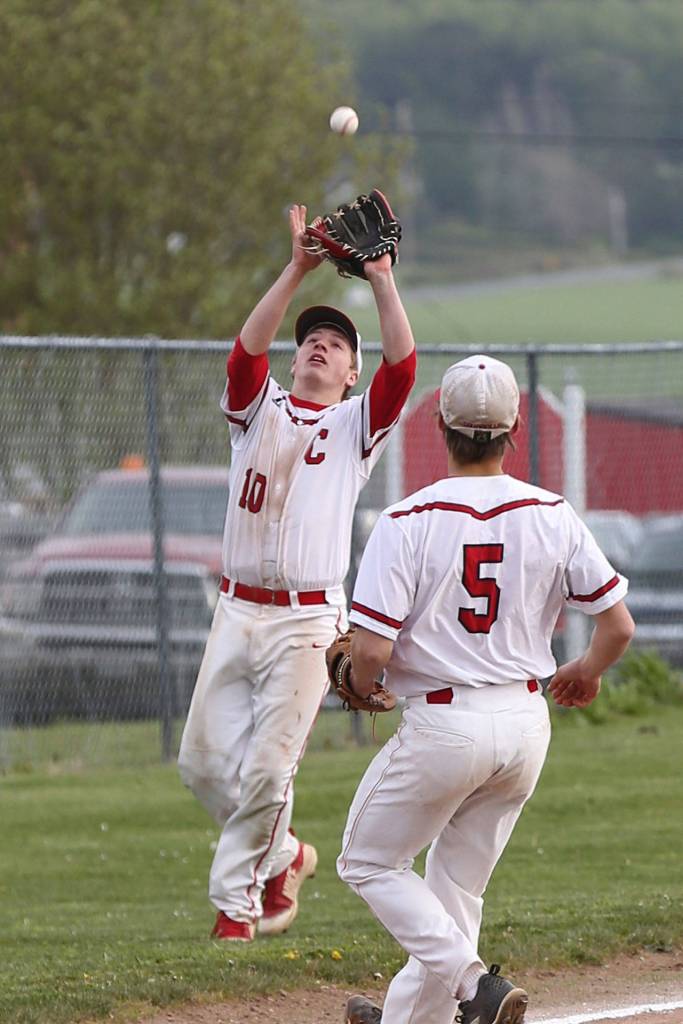 Third baseman Shane Losey settles under a p0p fly while Matt Hilborn looks on.(Photo by John Fisken)