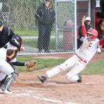 Coupevilles Jake Pease sides under the tag of Granite Falls Cameron Tappe to score a first-inning run for the Wolves.(Photo by John Fisken)