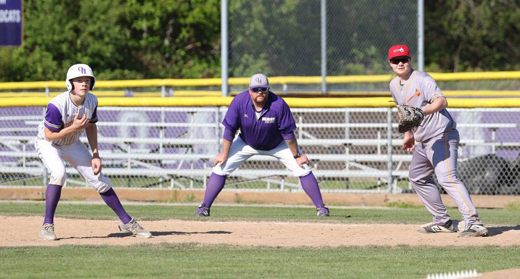 Noah Meffert leads of first base as coach Ryan McCarthy looks on.(Photo by John Fisken)
