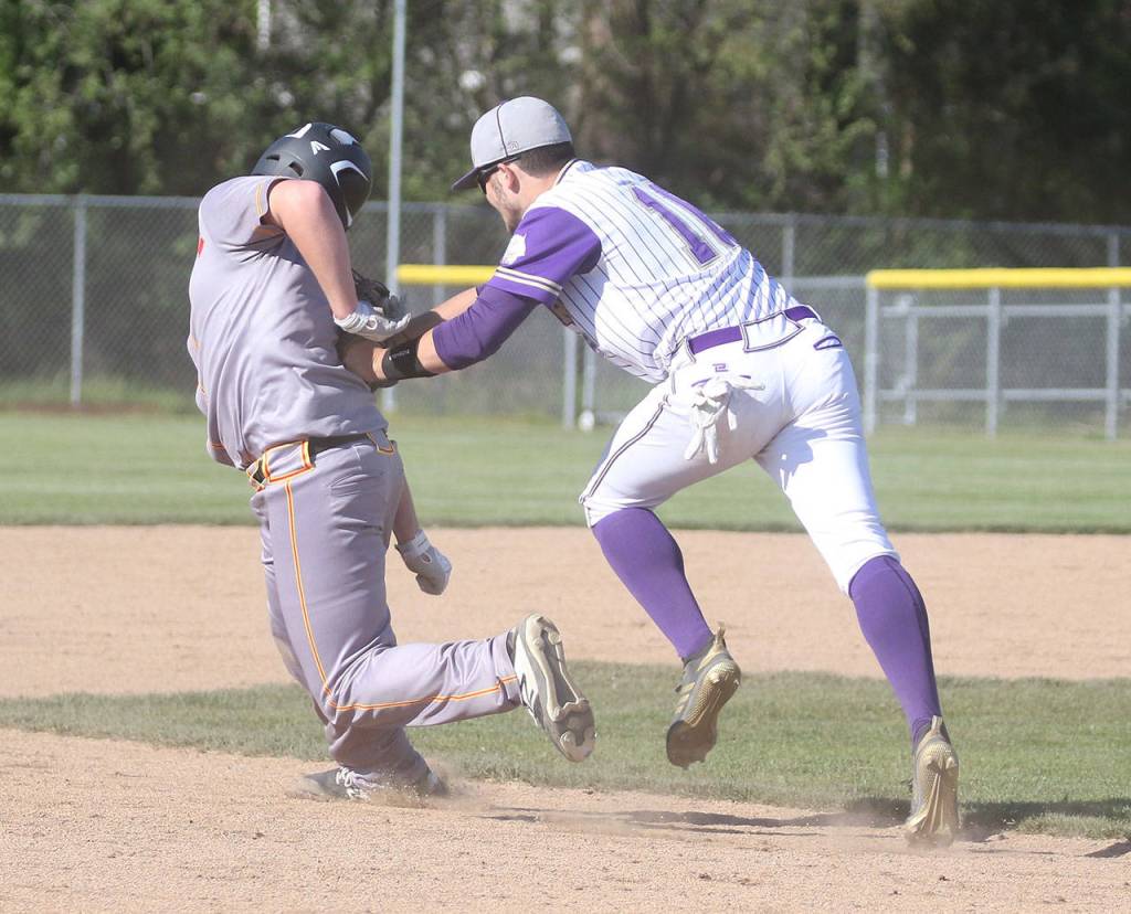 Taylor Rummel tags a Marysville-Pilchuck base runner.(Photo by John Fisken)
