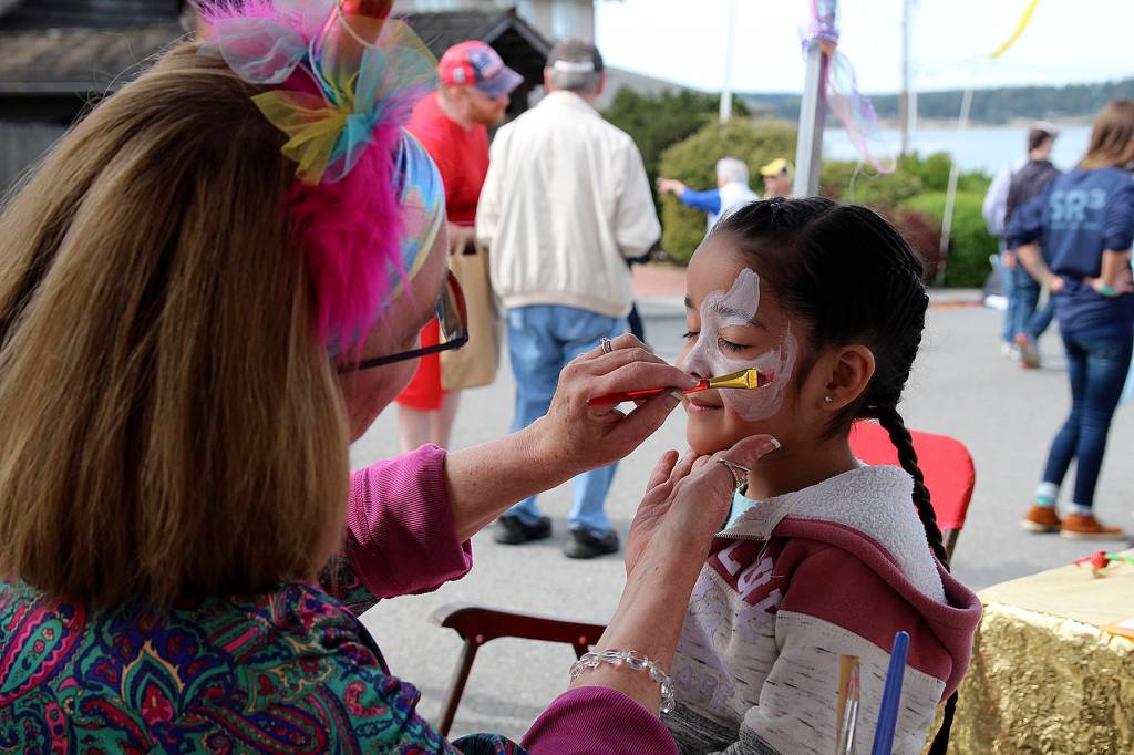 (Photo by Maria Matson/Whidbey News-Times)                                Four-year-old Delilah Rodriguez gets a unicorn painted on her face by Paula Mihok, of the Central Whidbey Lions Club. Delilahs father, Fernando Rodriguez, said it was their first time visiting the festival.
