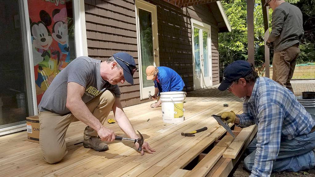 South Whidbey Hearts Hammers volunteers, including house captain Ken Murray, center, work on a project Saturday. (Photo provided)