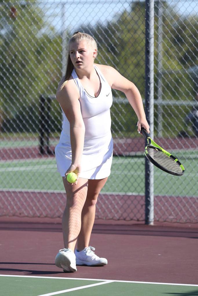 Avalon Renninger prepares to serve in first doubles.(Photo by John Fisken)