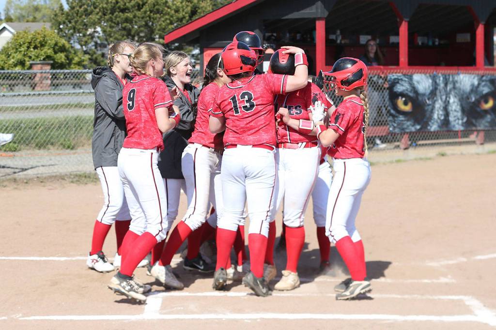Sarah Wright is mobbed by her teammates after hitting a first-inning home run.(Photo by John Fisken)