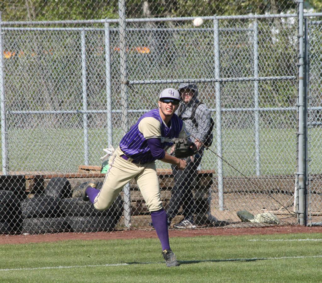 Third baseman Taylor Rummel throws to first after scooping up a slow roller.(Photo by Jim Waller/Whidbey News-Times)
