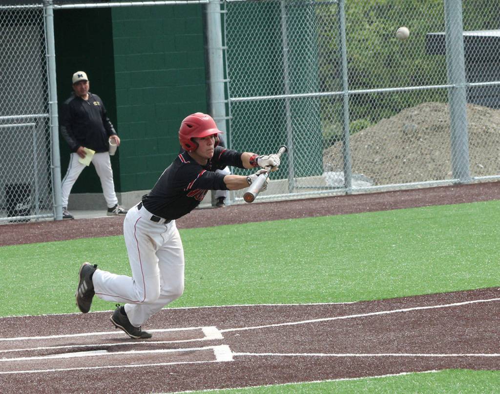 Matt Hilborns bunt moves up a runner against Meridian. (Photo by Jim Waller/Whidbey News-Times)