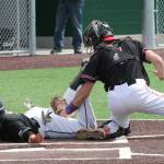 Coupeville catcher Gavin Knoblich appears to tag out Meridians Arturo Madrigal. Madrigal, however, was called safe on the play in the Trojans win.(Photo by Jim Waller/Whidbey News-Times)